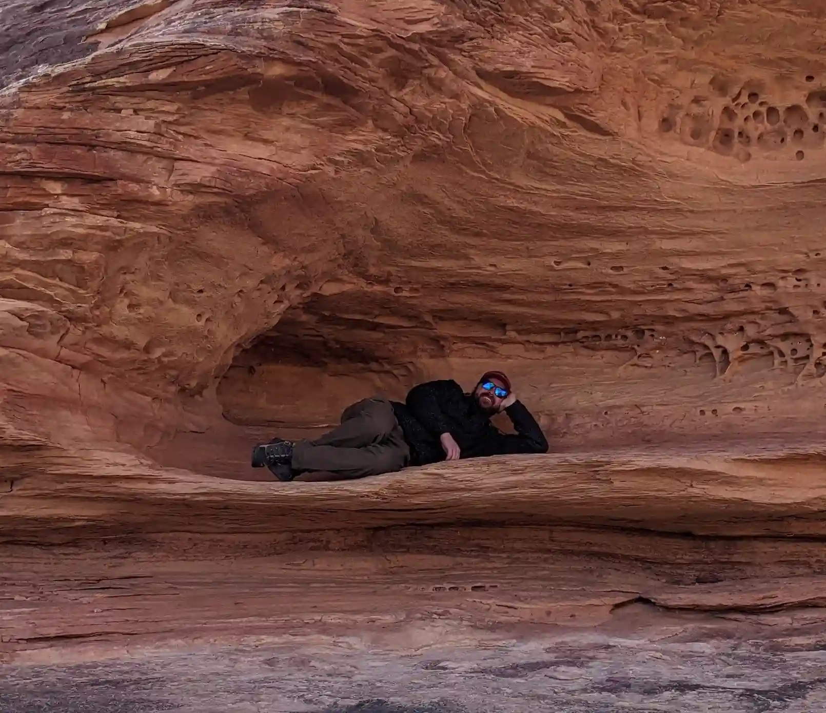 A man resting on a section of a mountain